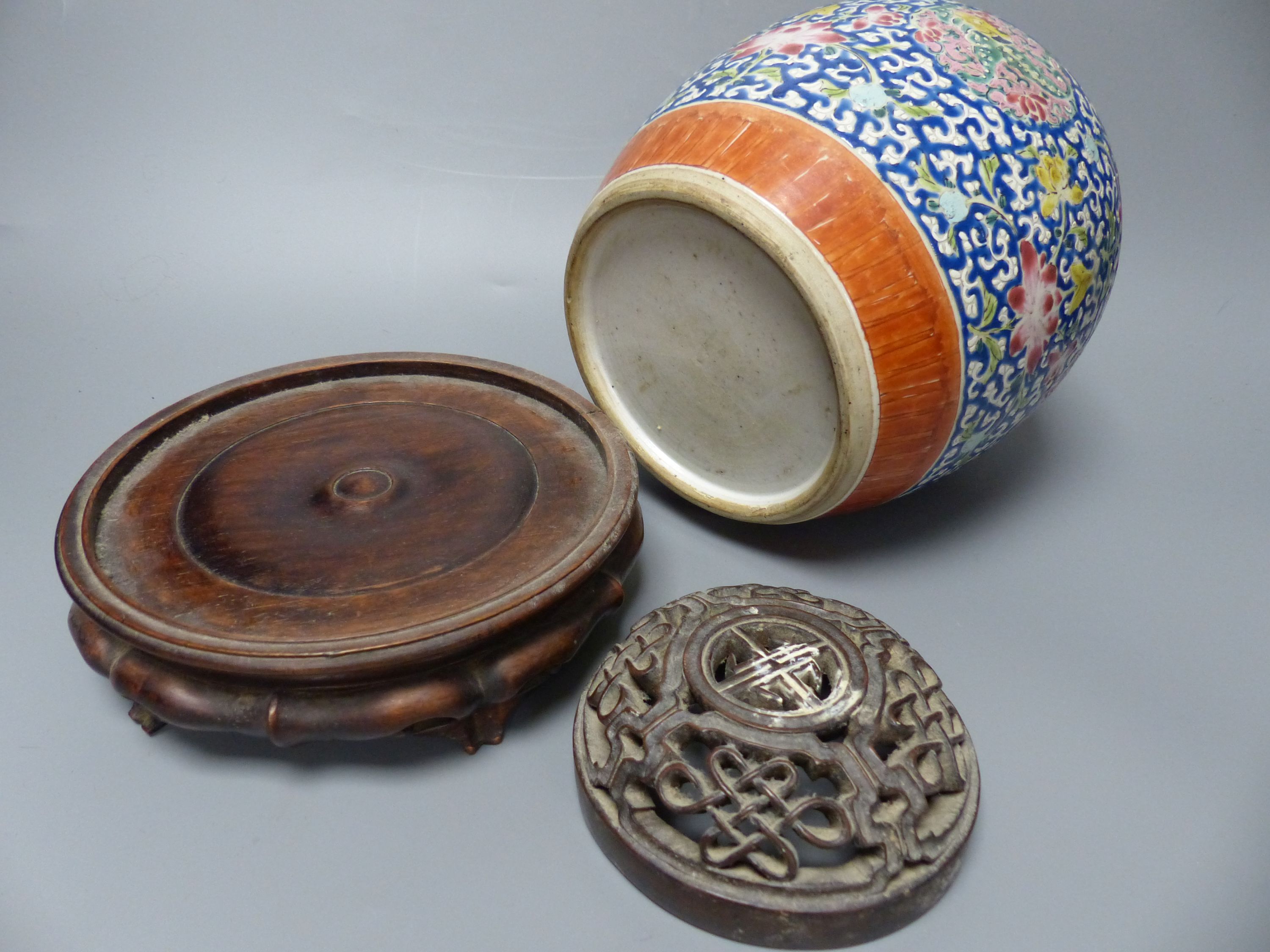 A 19th century Chinese enamelled jar with carved wood cover and stand, overall height 26cm